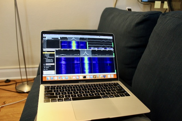 Photograph of laptop receiving signals on couch