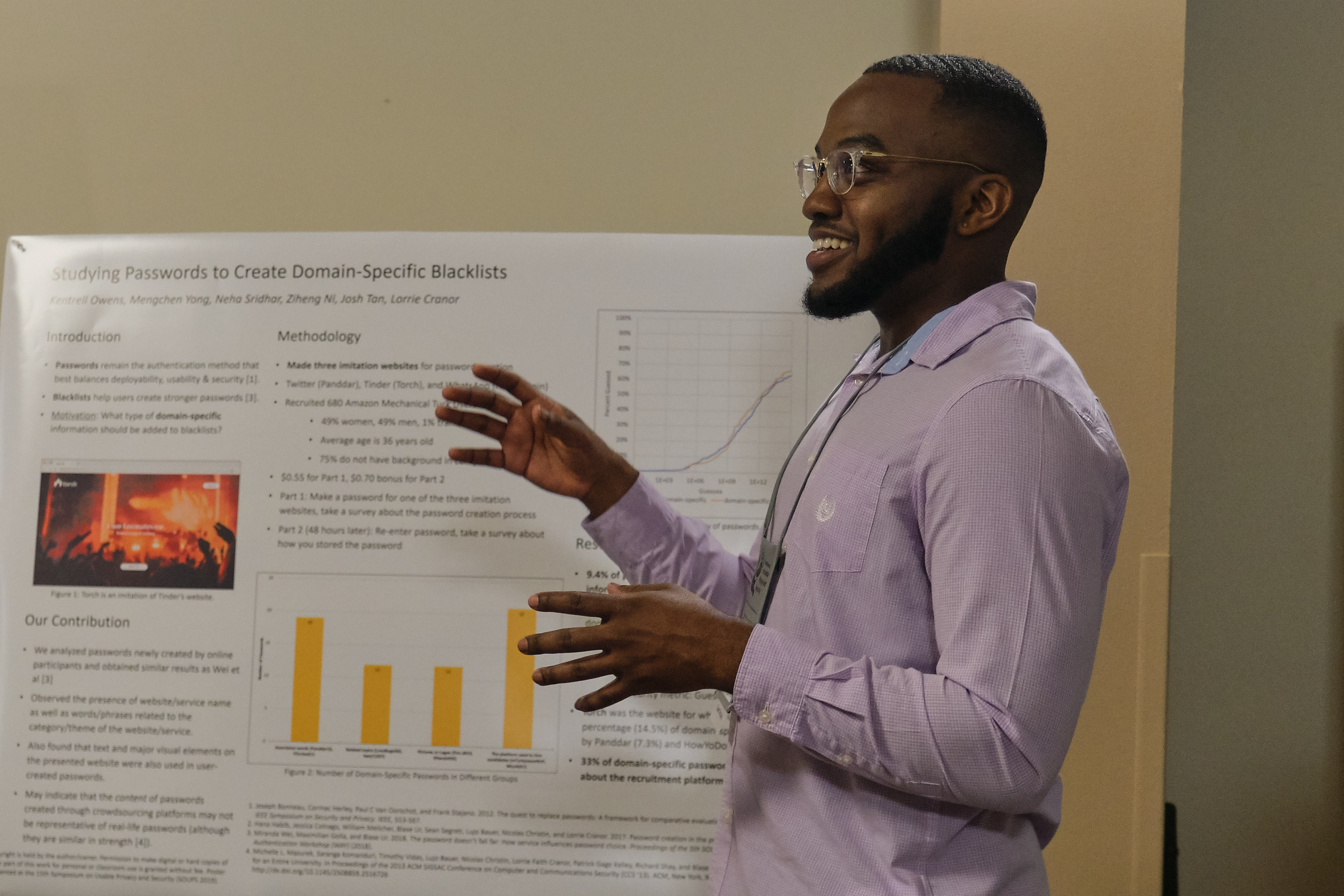 Picture of Kentrell Owens, a handsome young man, presenting a poster at a conference