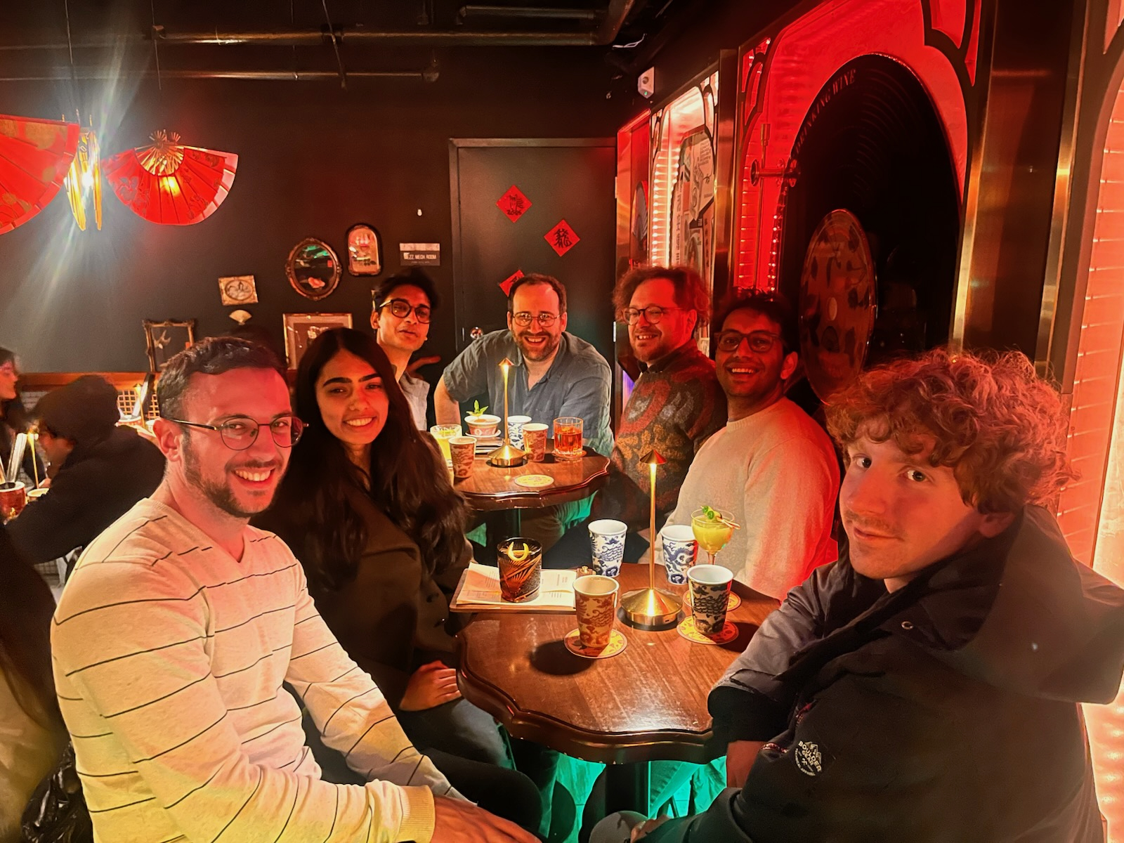 Group photo from the Winter 2026 quarterly outing to a cocktail bar in Capitol Hill, Seattle. From left to right: Assaf, Shreya, Arjun, Joe, Gilbert (a professor at UW and friend of the lab), Chinmay, and Nick.